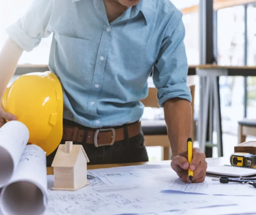A person drawing building plans