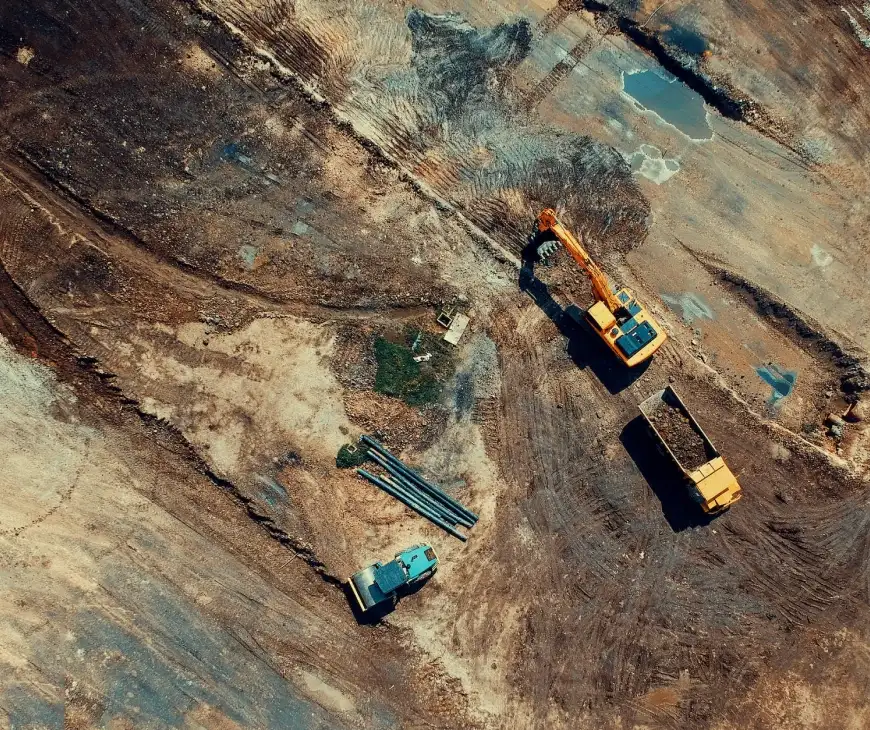 An excavator and a truck on a work site
